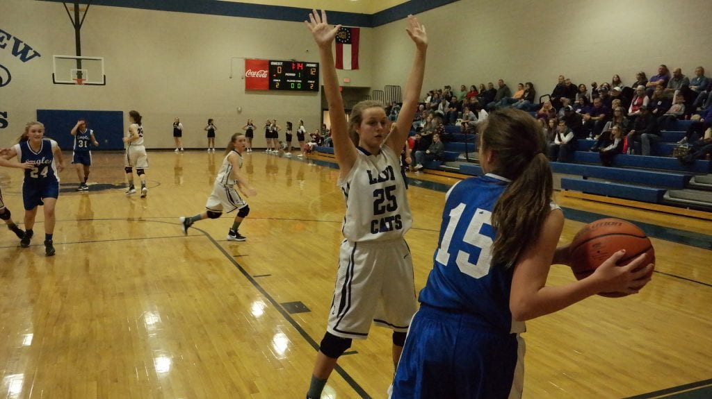 Seventh-grade Lady Cat Emma Callihan (25) looks to break up Lady Eagle Shyla Sheffield's (15) in-bound pass. Clear Creek defeated Riverview 45-8 yesterday, to advance to the seventh-grade girls NGML championship game. (Photo by: Kevin Hensley).