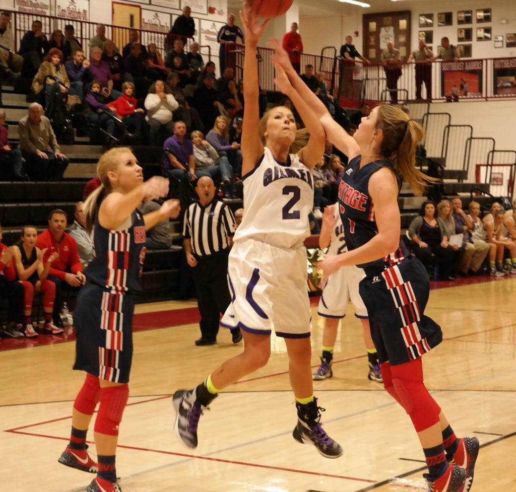 Lady Cat Hannah Jones reaches over a Lady General for a basket last Friday in the Region 7-4A semifinal game at Southeast Whitfield High School in Dalton. Gilmer went on to fall to Heritage, 61-44. (Photo by: Kevin Hensley)