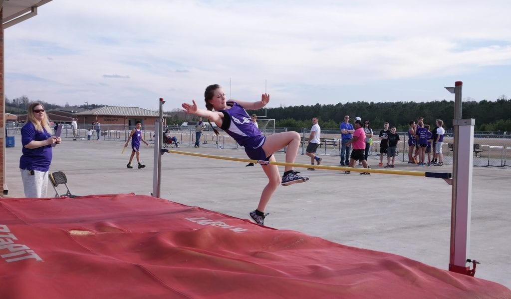 Lady Cat Heather Craig leaps over the bar, during the high jump competition last Tuesday against Lumpkin. Craig won both the high and triple jump events for Clear Creek. (Photo by: Kevin Hensley)