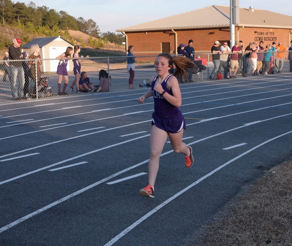 Lady Cats Ardyn Weaver sprints around the track, during a meet against Lumpkin March 8. Weaver won both the 800 and 1600-meter races at the Warrior Invitational last Saturday, with respective times of 2:41.99 and 5:50.17. (Photo by: Kevin Hensley)