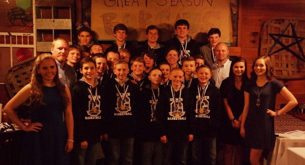 Pictured is the 2015-16 Clear Creek Middle School Bobcats basketball team and its managers, along with coaches Tim Davis (left) and Michael Crocker (right). (Photo by: Kevin Hensley)